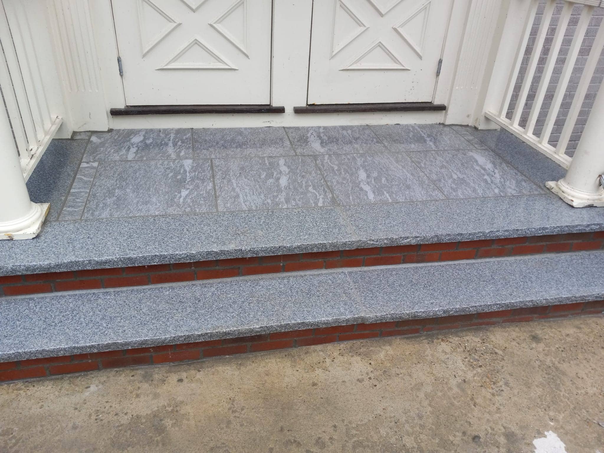 Granite-tile front stoop with brick risers
