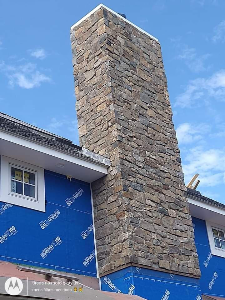 Custom natural stone chimney shaft with bluestone cap