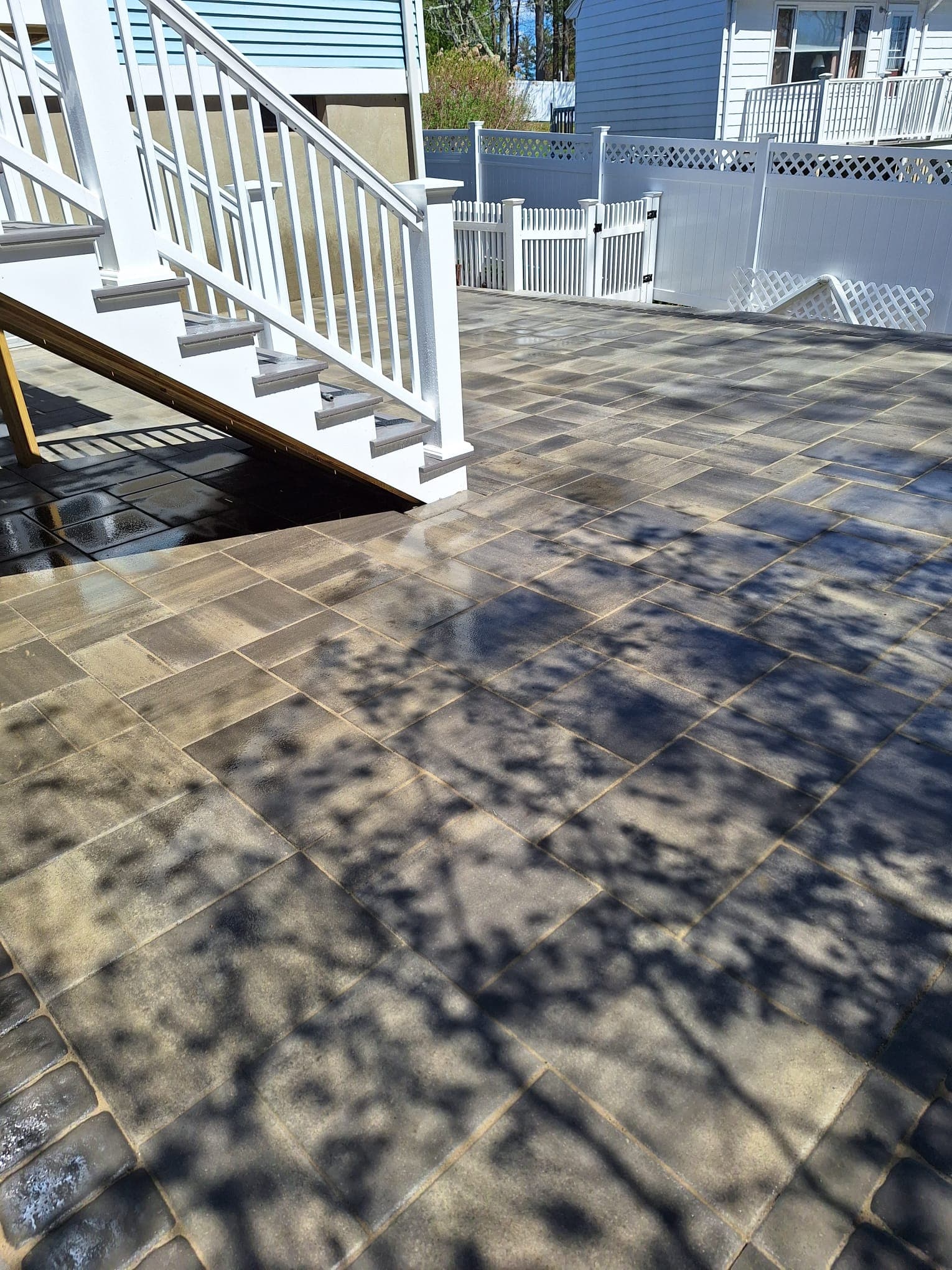 Wide paver patio with stair access from deck